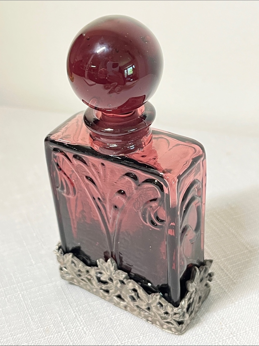 Vintage perfume bottle amethyst purple glass body 
encased ornate floral pewter
